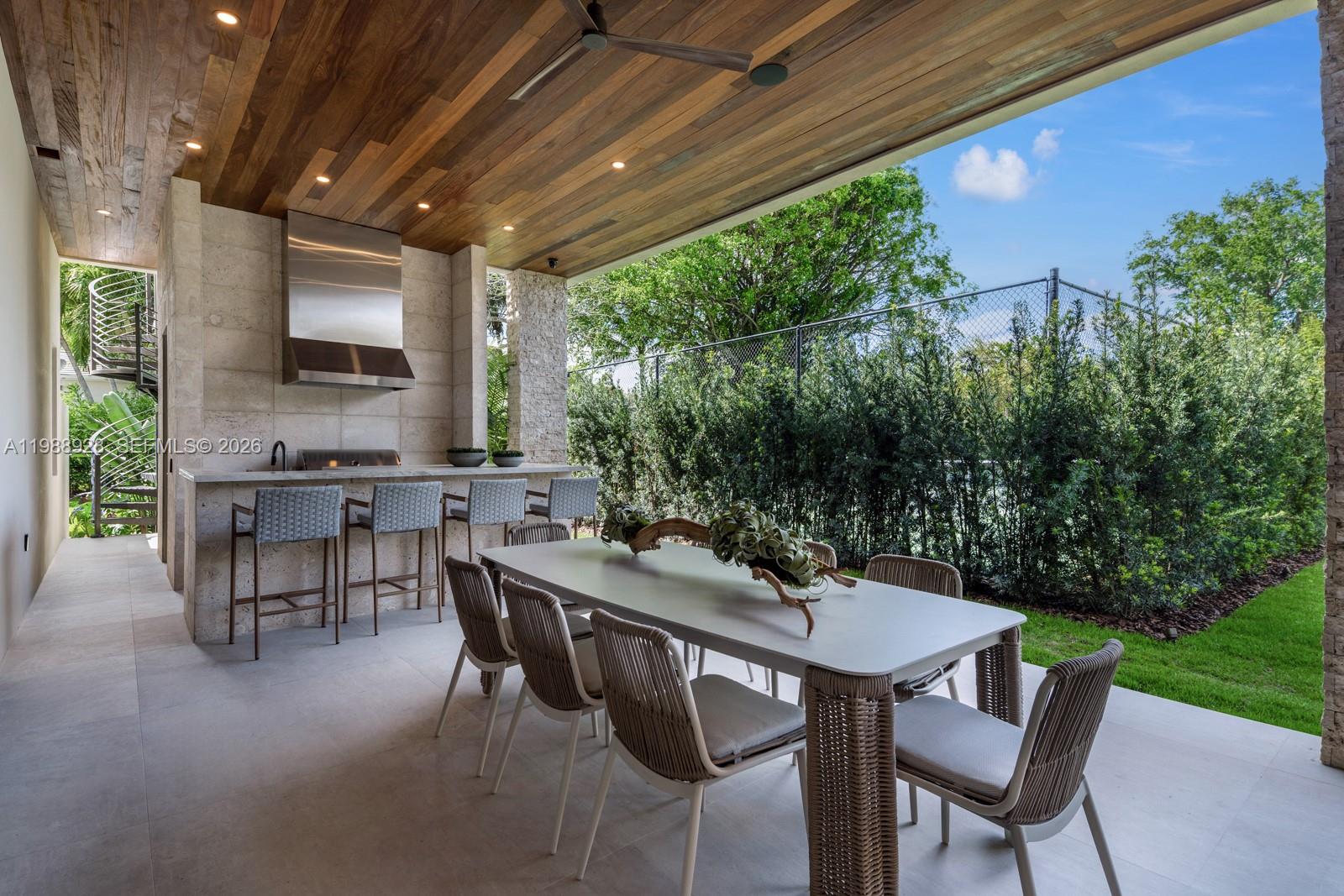 5545 Southwest 81st Terrace Miami, FL 33143 - Photo 72 of 100 a view of an outdoor dining space with a table and chairs