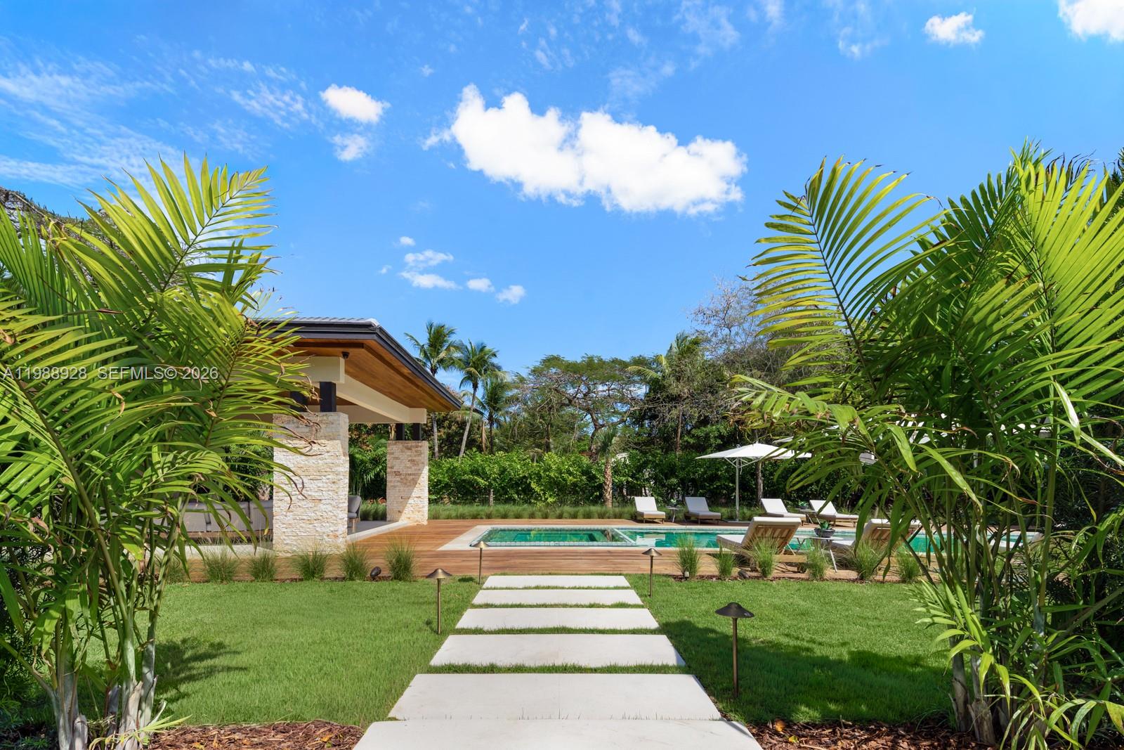 5545 Southwest 81st Terrace Miami, FL 33143 - Photo 100 of 100 a front view of a house with a yard and potted plants