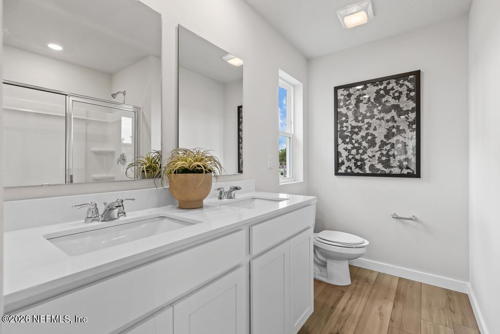 10700 Waterfield Road Jacksonville, FL 32210 - Photo 29 of 39 a bathroom with a toilet sink and mirror