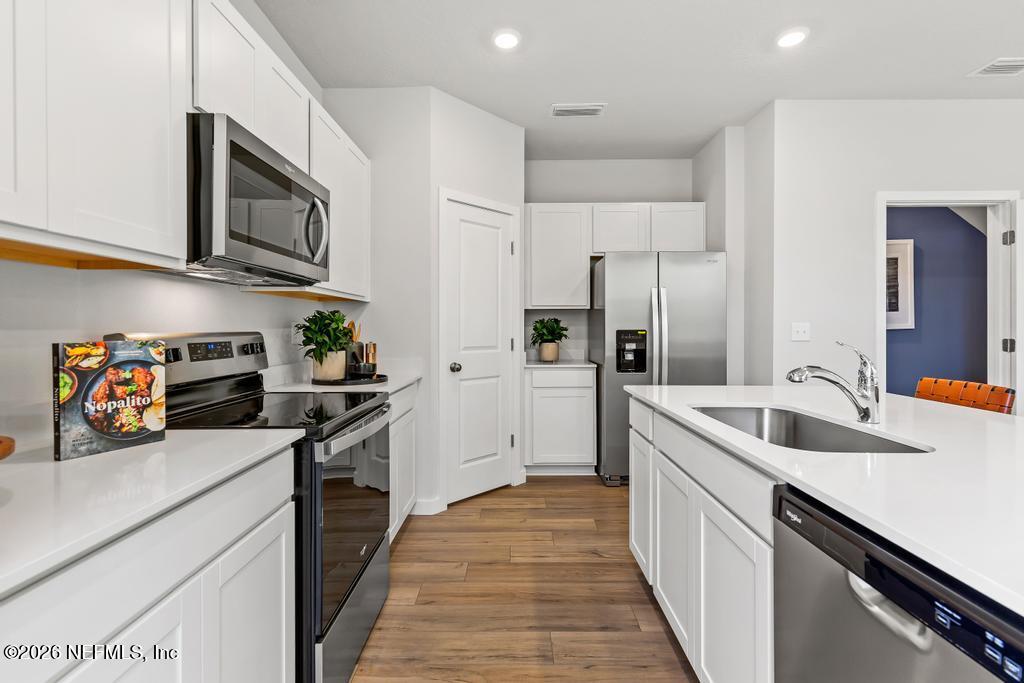 10700 Waterfield Road Jacksonville, FL 32210 - Photo 5 of 39 a kitchen with stainless steel appliances granite countertop a sink stove and refrigerator