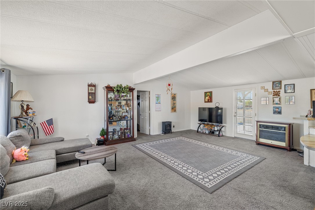 3581 West Dyer Road Pahrump, NV 89048 - Photo 6 of 31 Carpeted living room with baseboards