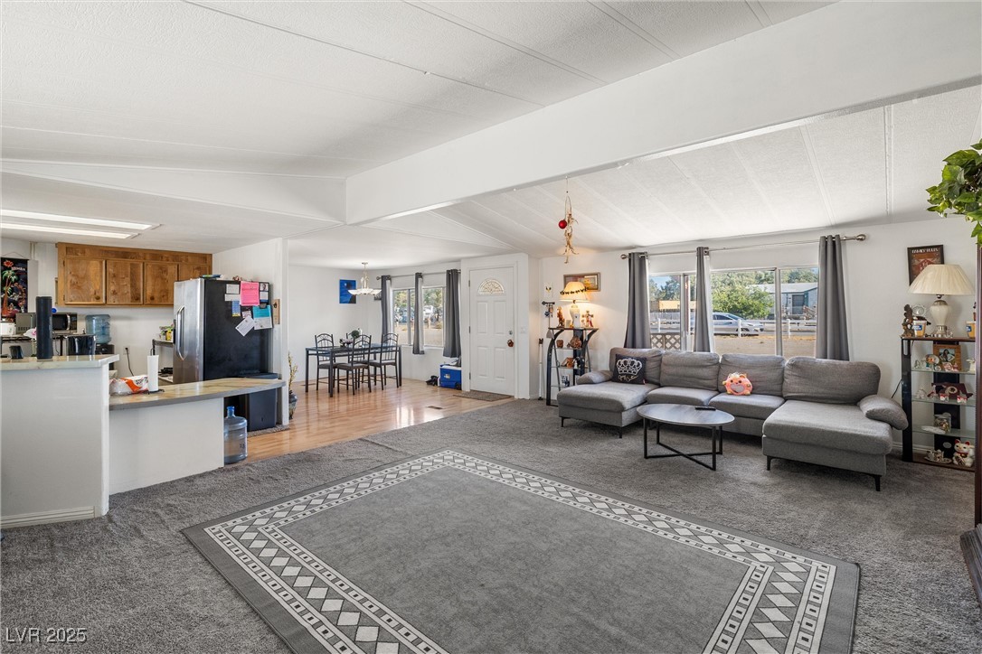 3581 West Dyer Road Pahrump, NV 89048 - Photo 8 of 31 Living area with healthy amount of natural light and light carpet