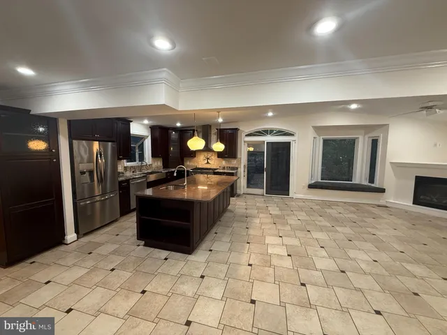 an empty room with windows and fireplace