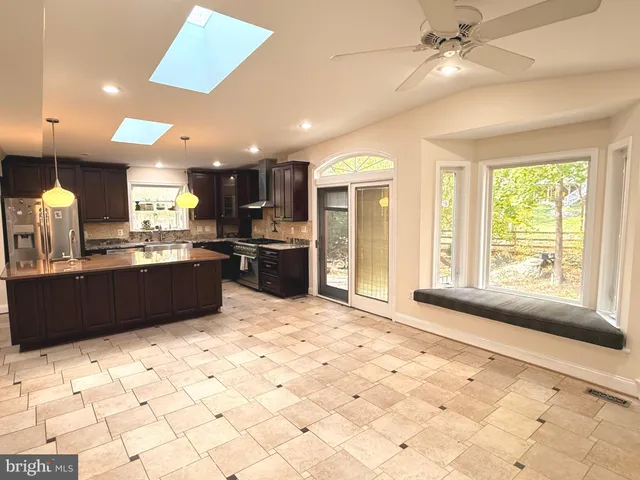 a view of empty room with fireplace and wooden floor