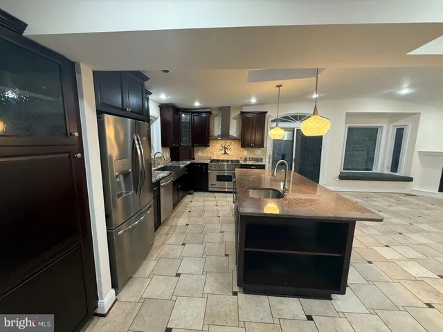 a view of empty room with wooden floor and fireplace