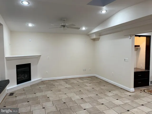 an empty room with a window and wooden floor
