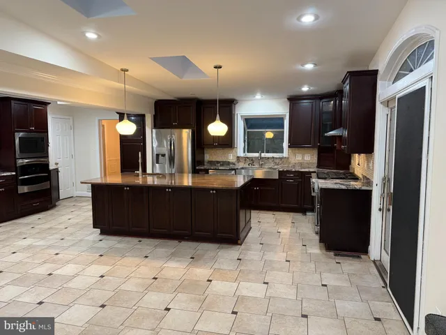 a view of a room with wooden floor and chandelier