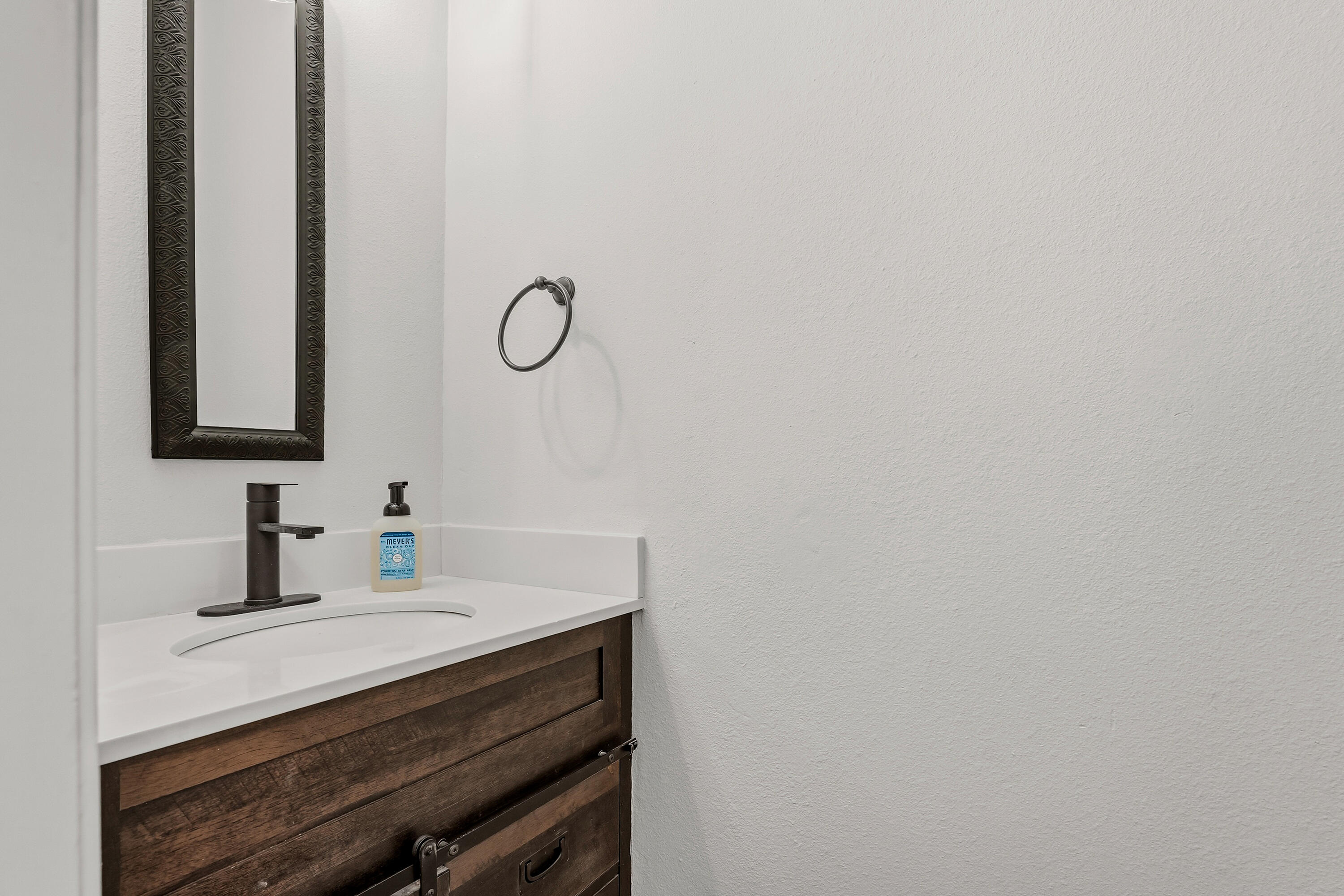 5002 94th Street Lubbock, TX 79424 - Photo 13 of 30 a bathroom with a sink and a mirror