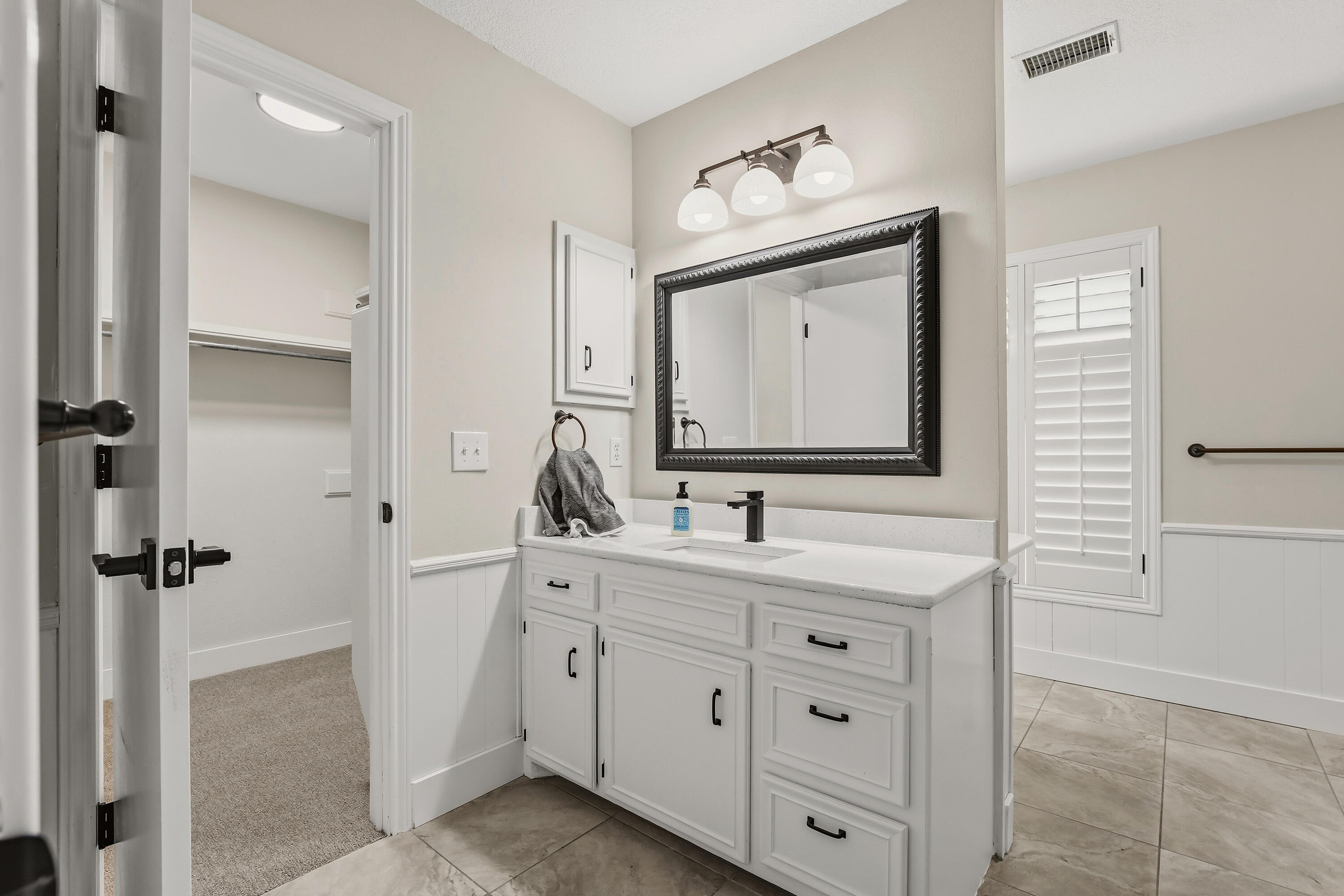 5002 94th Street Lubbock, TX 79424 - Photo 16 of 30 a bathroom with a double vanity sink and mirror