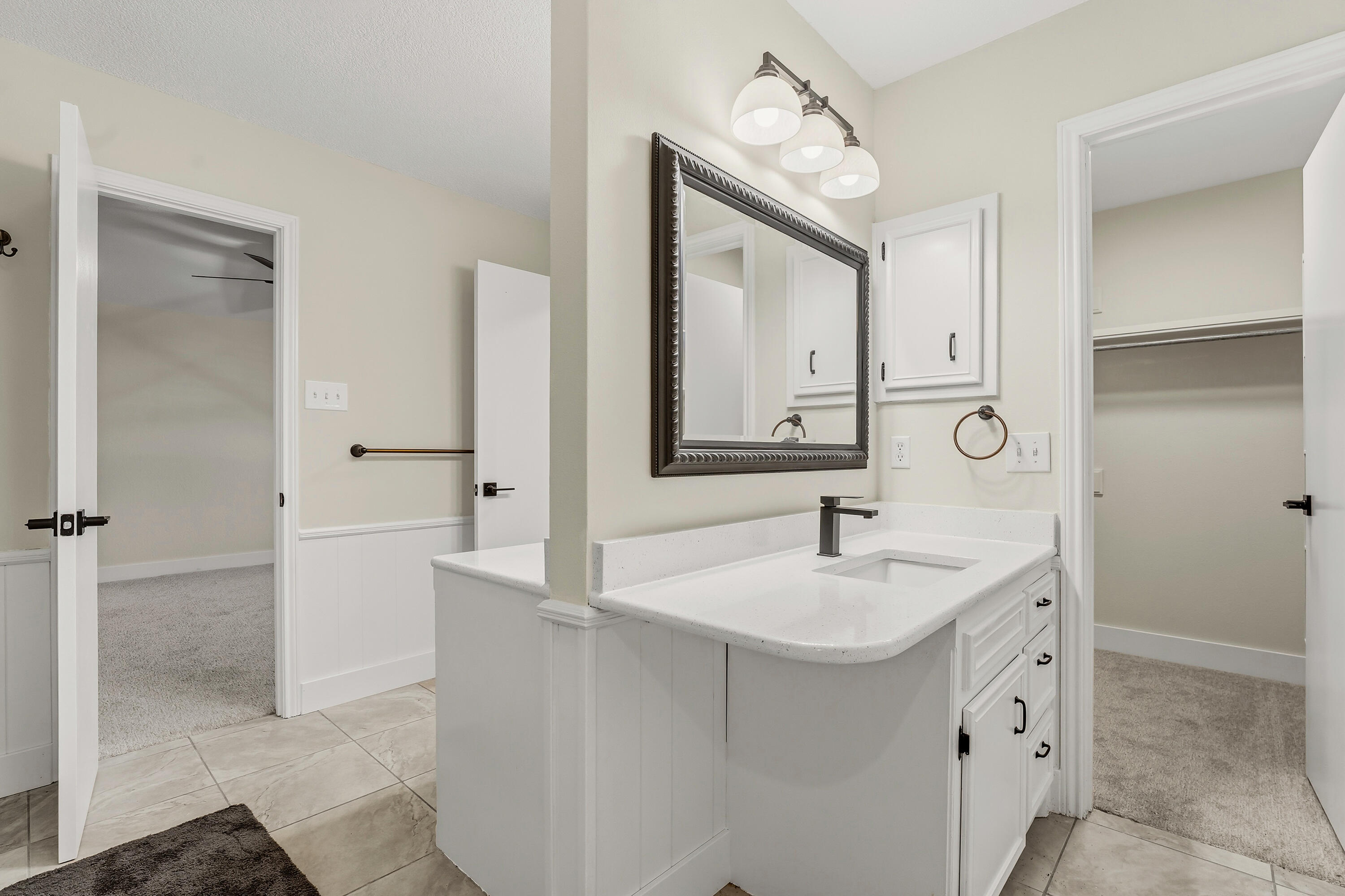 5002 94th Street Lubbock, TX 79424 - Photo 17 of 30 a bathroom with a sink a vanity and a mirror