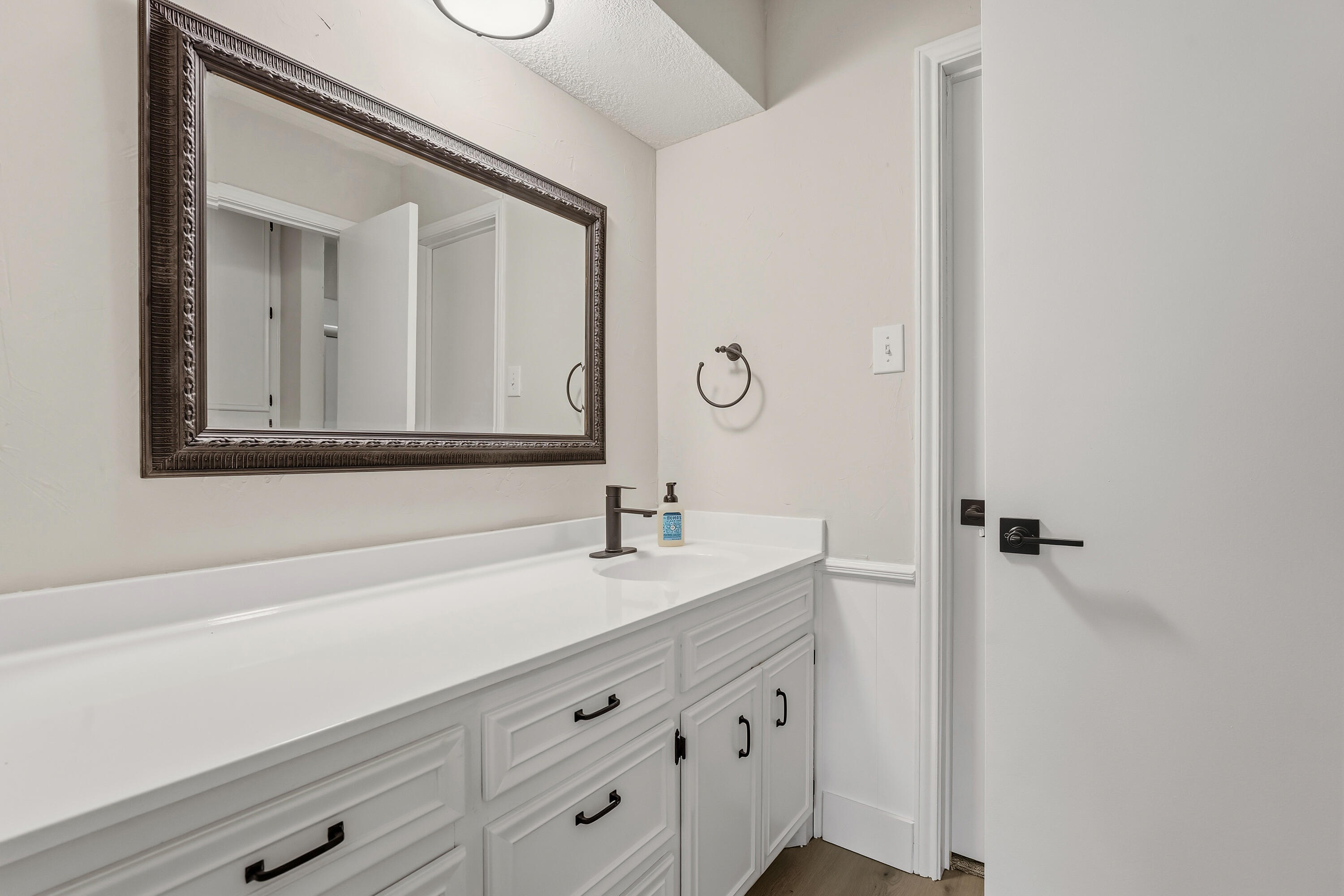 5002 94th Street Lubbock, TX 79424 - Photo 18 of 30 a bathroom with a sink and a mirror