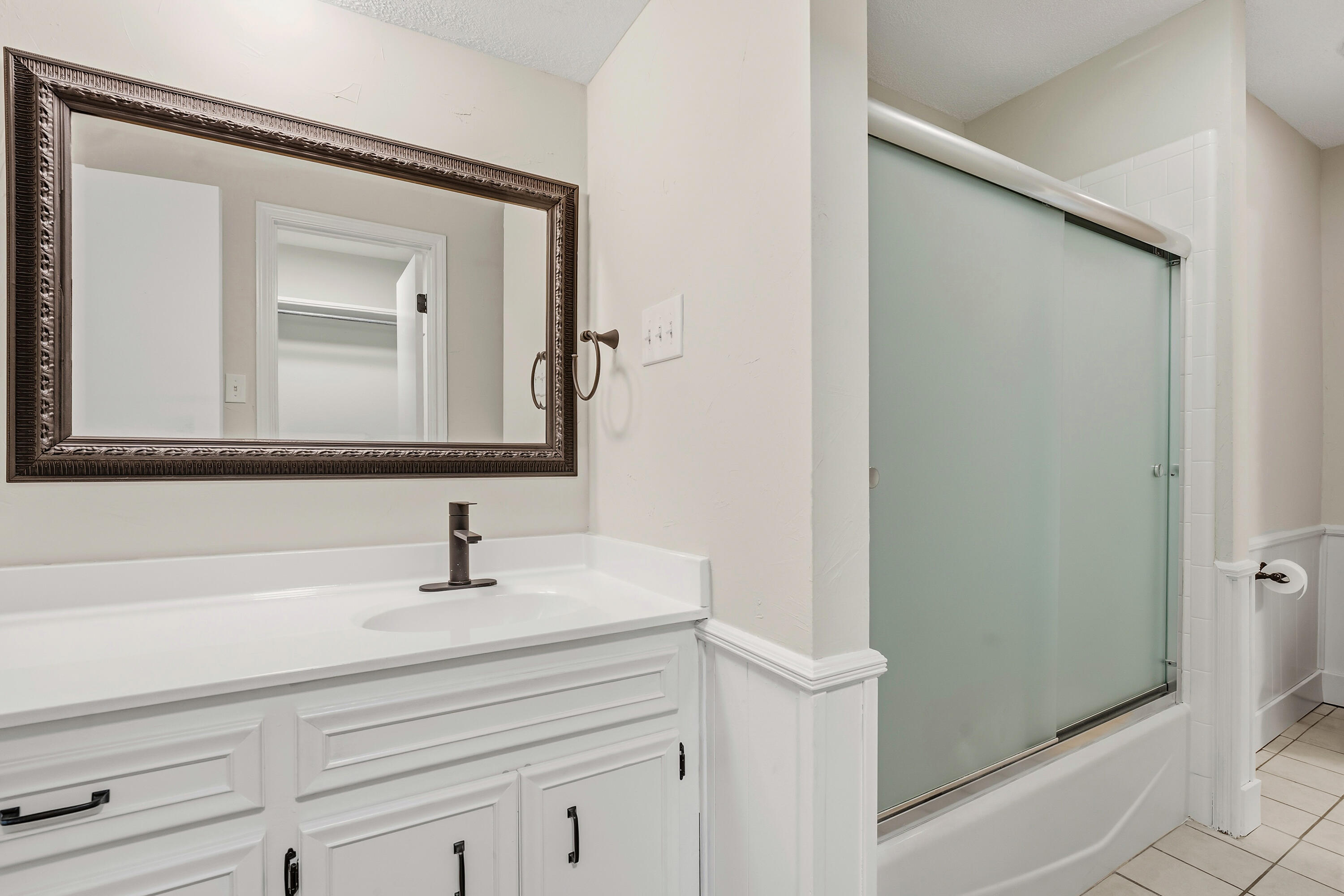 5002 94th Street Lubbock, TX 79424 - Photo 19 of 30 a bathroom with a sink and a mirror