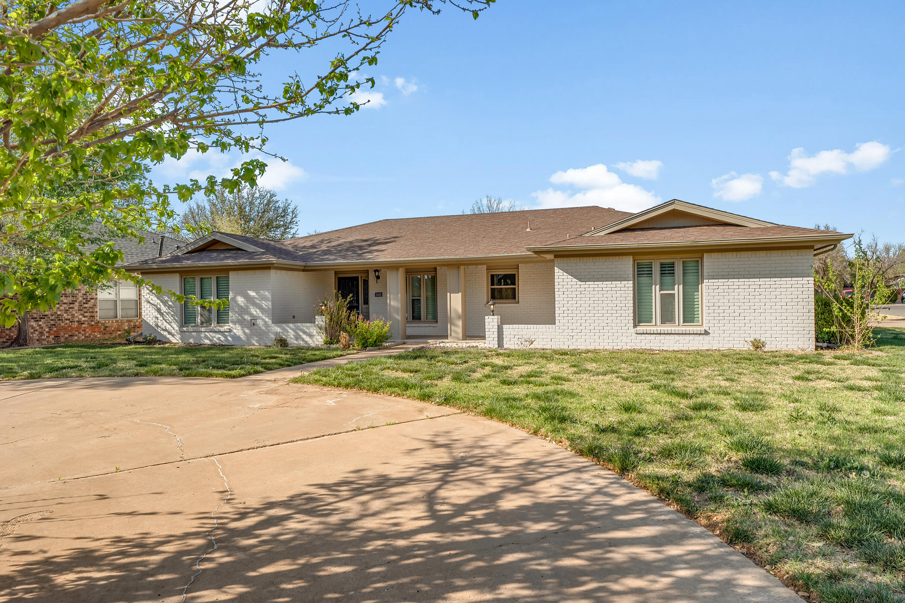 5002 94th Street Lubbock, TX 79424 - Photo 2 of 30 a front view of a house with a garden