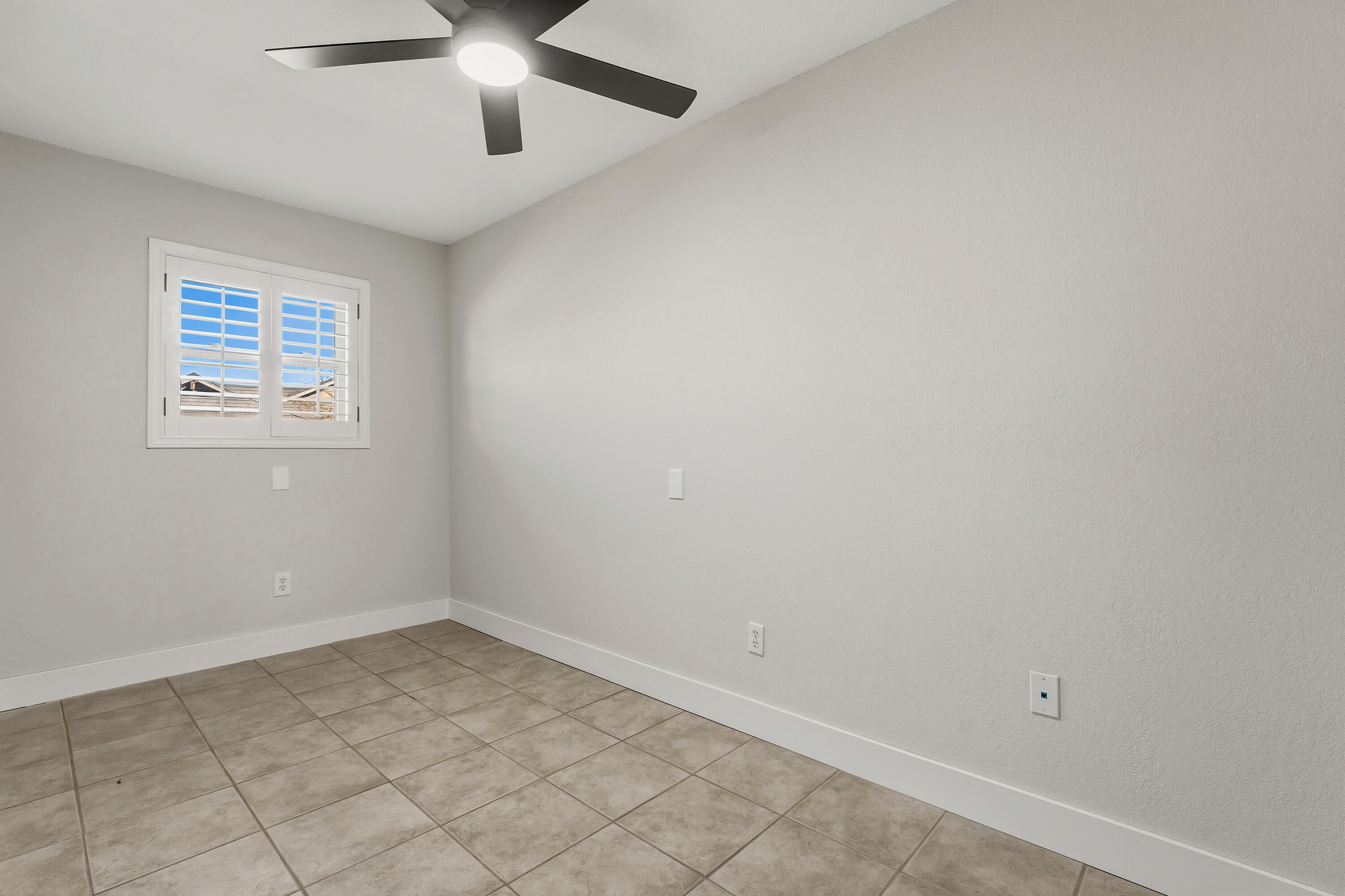 5002 94th Street Lubbock, TX 79424 - Photo 27 of 30 an empty room with a ceiling fan and window