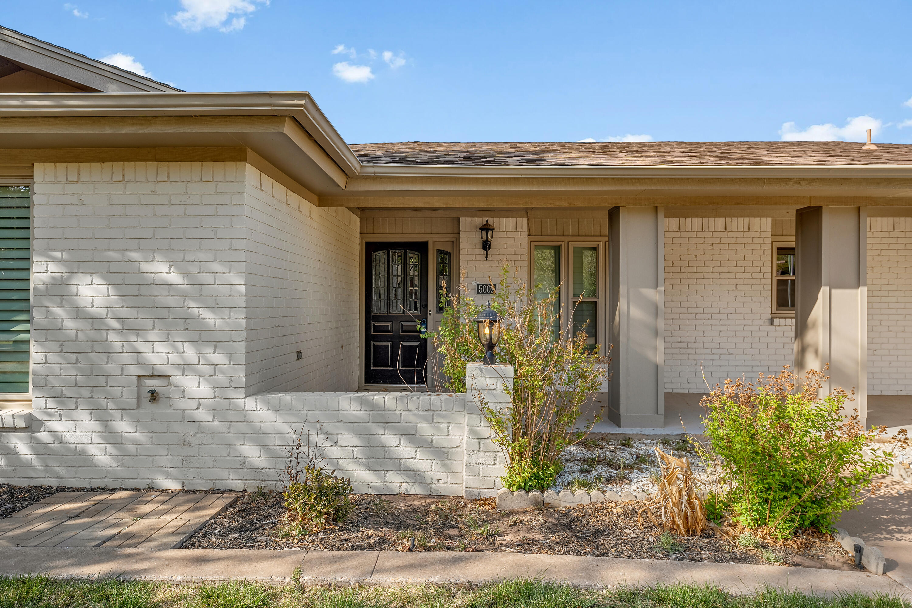 5002 94th Street Lubbock, TX 79424 - Photo 3 of 30 a view of a house with potted plants