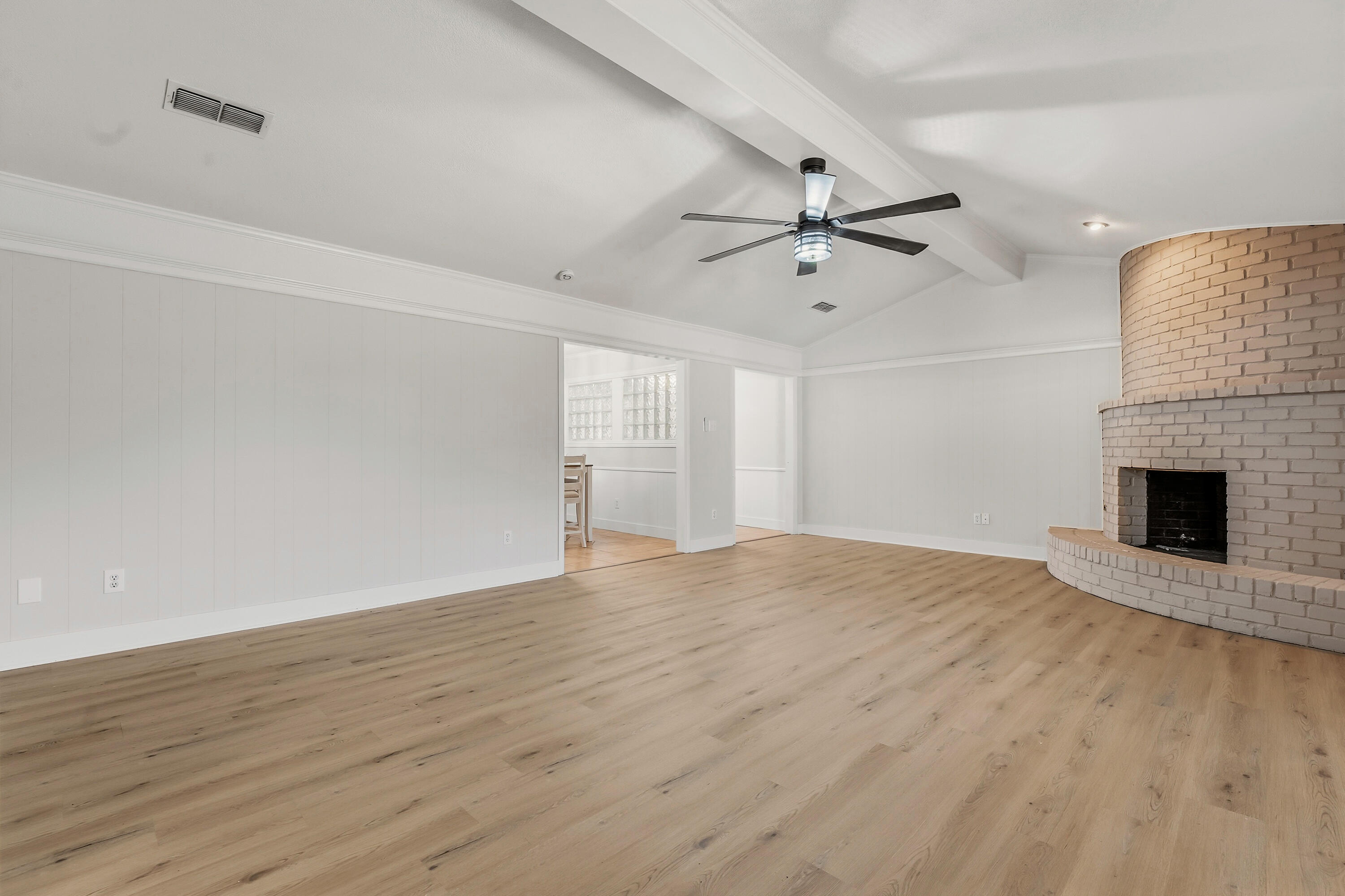 5002 94th Street Lubbock, TX 79424 - Photo 5 of 30 wooden floor in an empty room with a fireplace