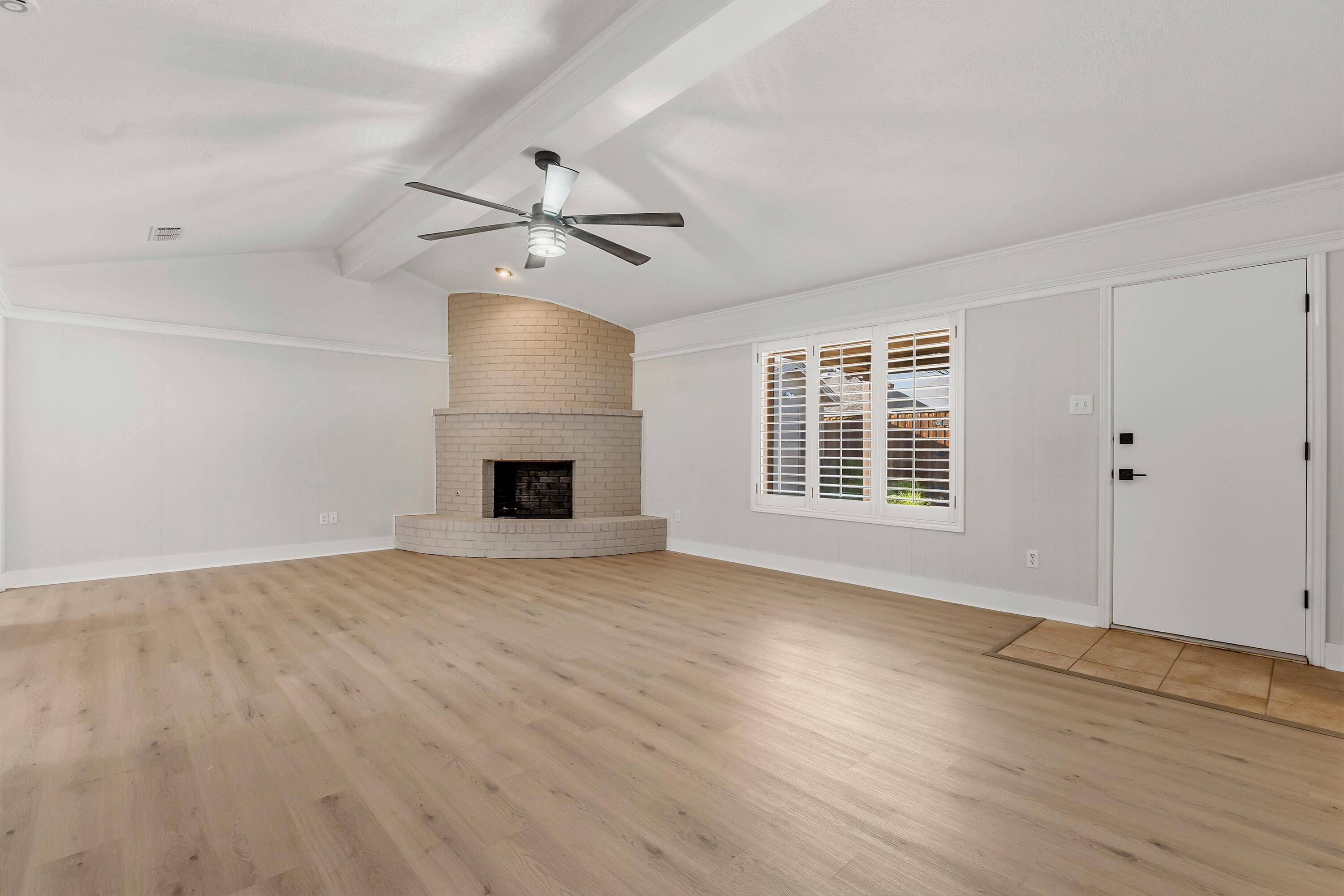 5002 94th Street Lubbock, TX 79424 - Photo 6 of 30 a view of an empty room with a fireplace and a window