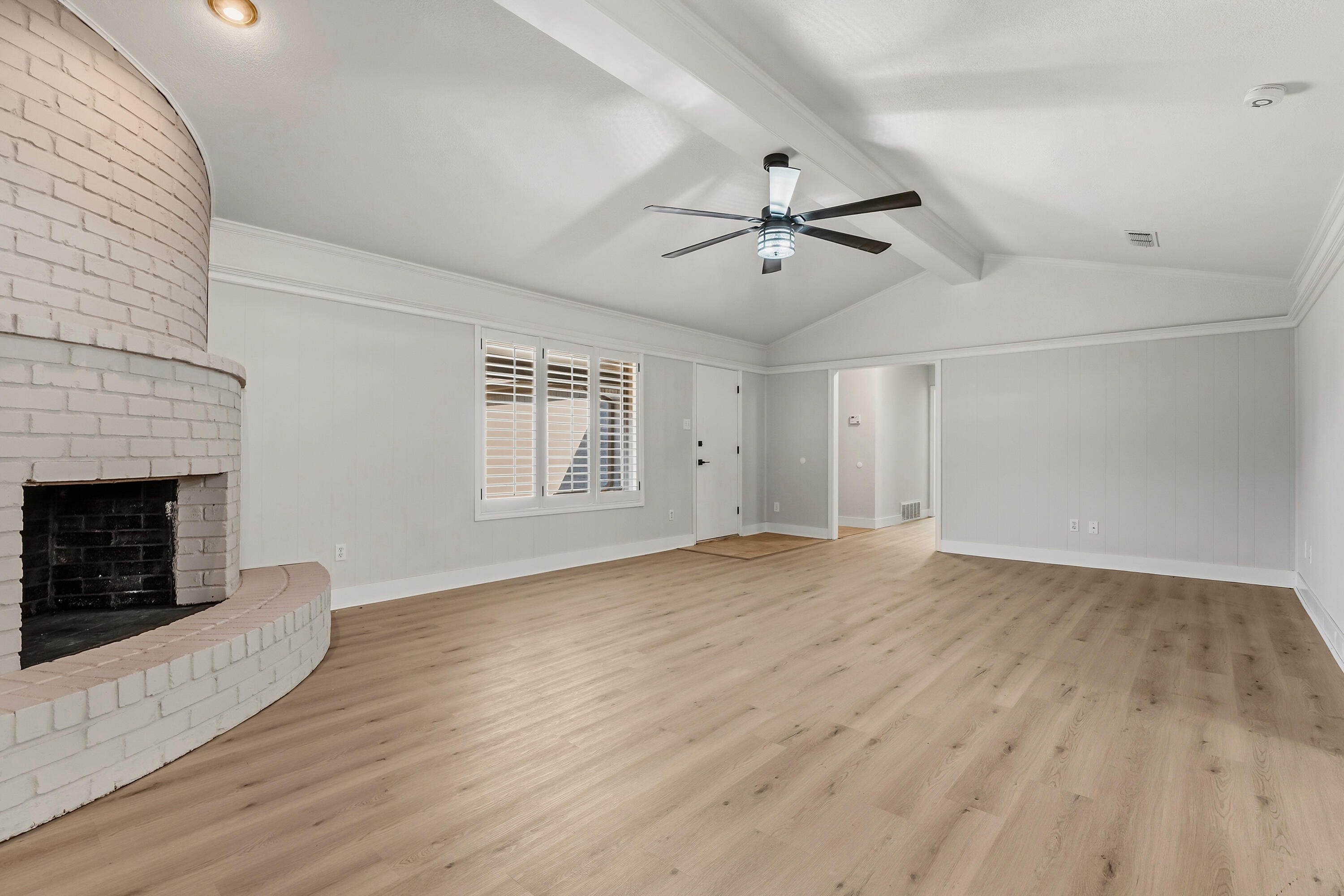 5002 94th Street Lubbock, TX 79424 - Photo 7 of 30 wooden floor in an empty room with a fireplace