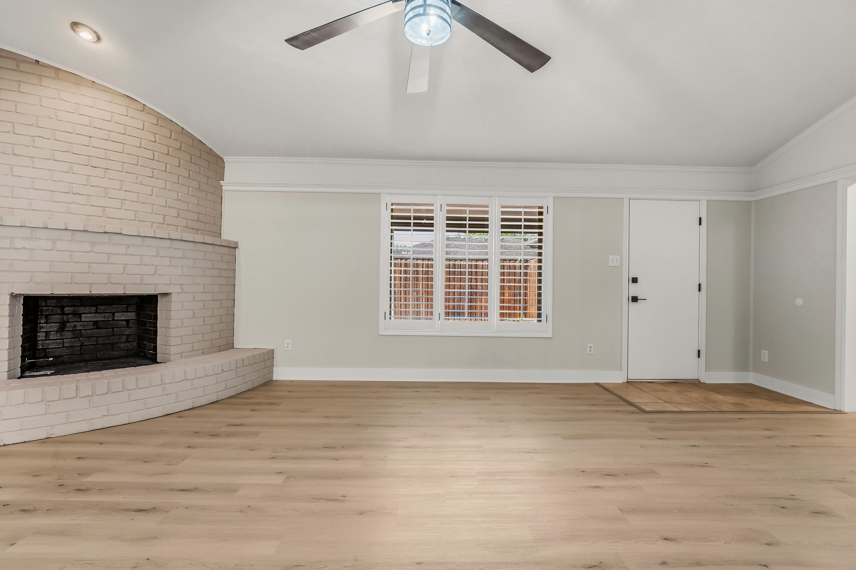 5002 94th Street Lubbock, TX 79424 - Photo 8 of 30 a view of an empty room with a fireplace and a window