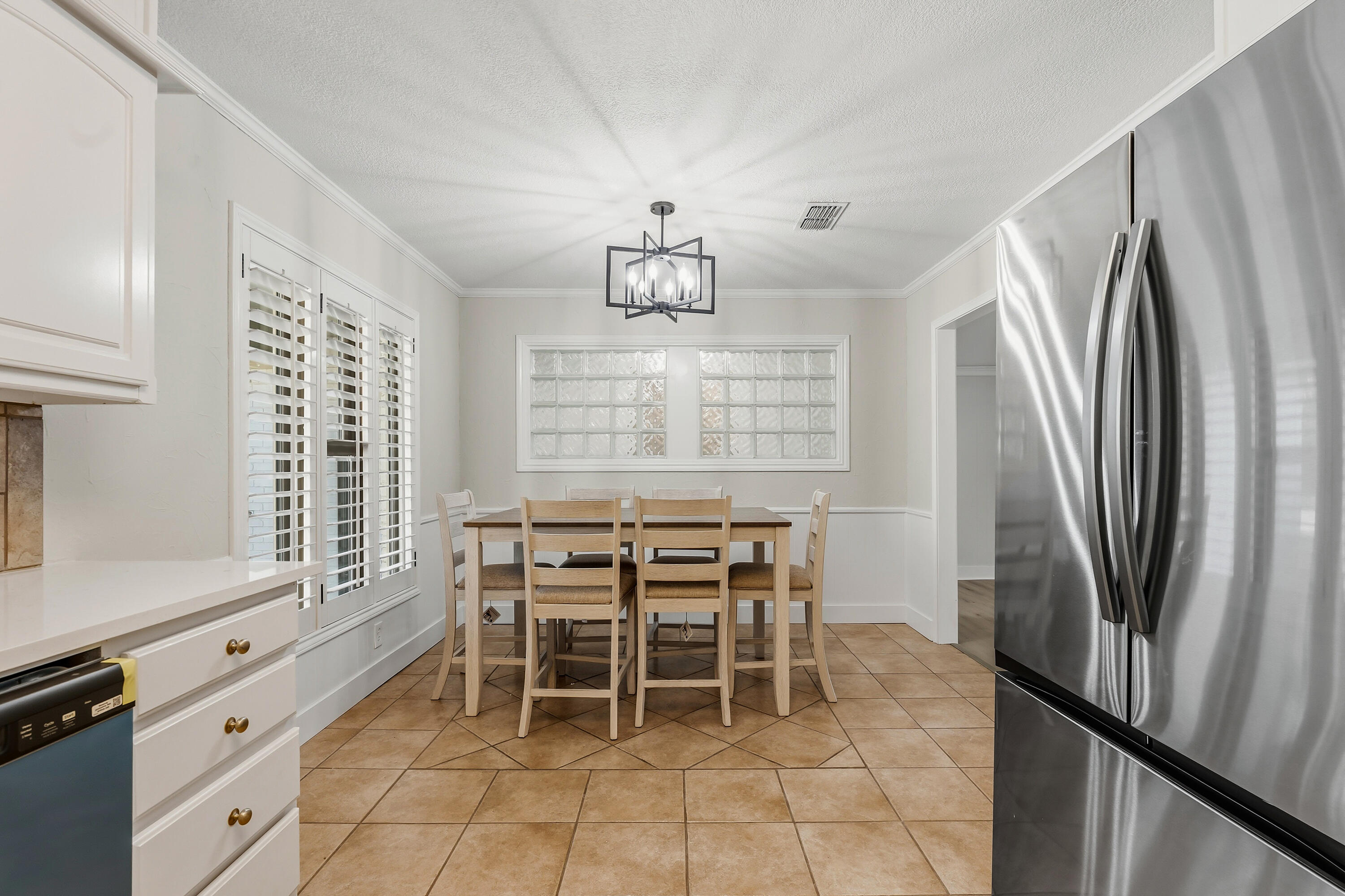 5002 94th Street Lubbock, TX 79424 - Photo 10 of 30 a dining room with a window and stainless steel appliances