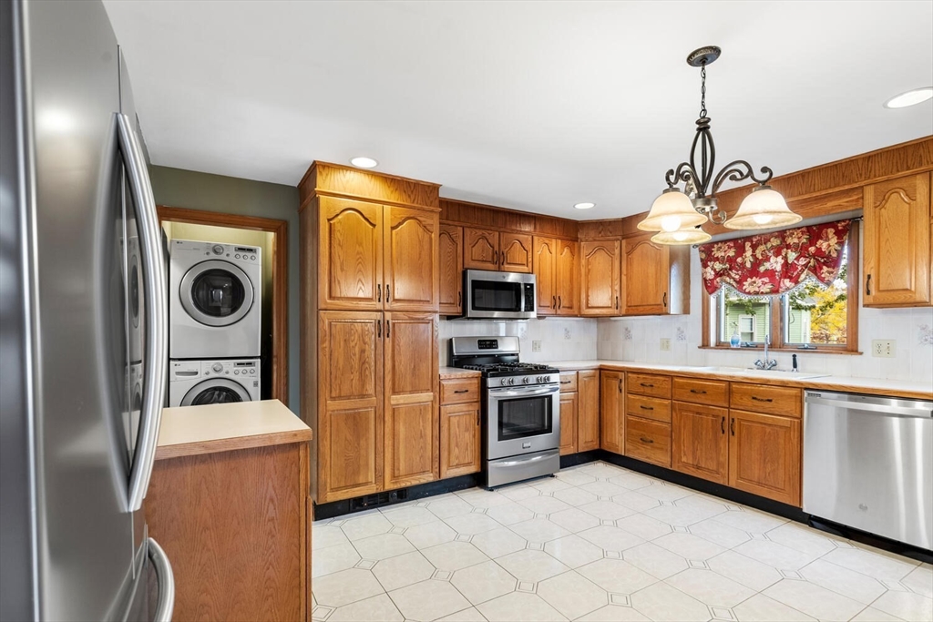 a kitchen with stainless steel appliances granite countertop a sink and refrigerator
