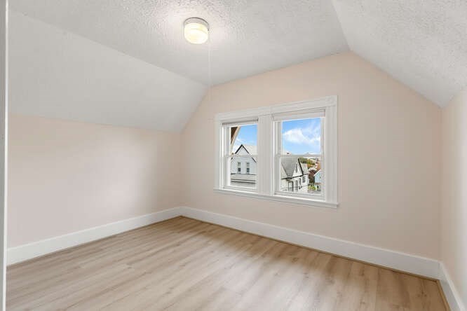 20 Fairmount Street, Unit 2 Everett, MA 02149 - Photo 11 of 12 an empty room with wooden floor and windows