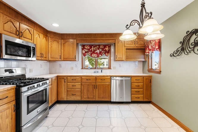 20 Fairmount Street, Unit 2 Everett, MA 02149 - Photo 2 of 12 a kitchen with stainless steel appliances granite countertop a stove a sink and a microwave