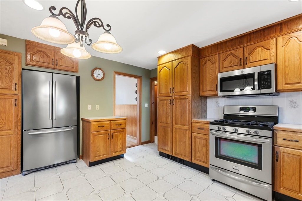 20 Fairmount Street, Unit 2 Everett, MA 02149 - Photo 3 of 12 a kitchen with stainless steel appliances granite countertop a refrigerator a stove top oven a sink and dishwasher