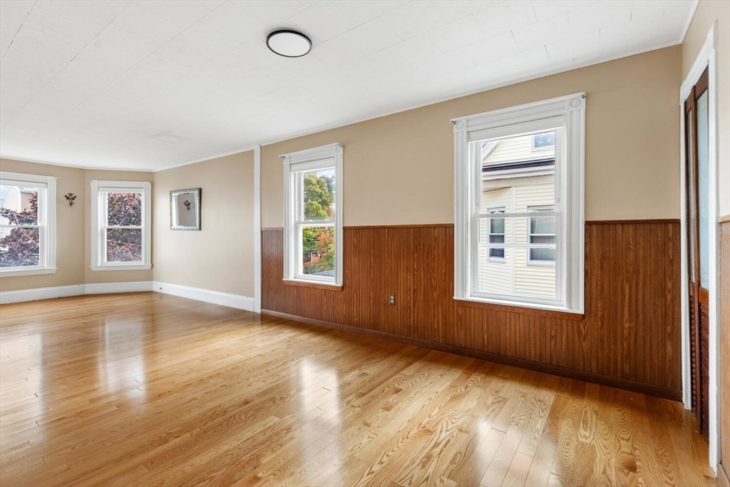 20 Fairmount Street, Unit 2 Everett, MA 02149 - Photo 5 of 12 a view of an empty room with wooden floor and a window