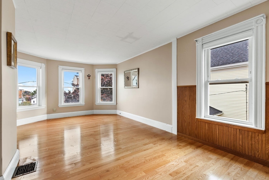 20 Fairmount Street, Unit 2 Everett, MA 02149 - Photo 7 of 12 a view of an empty room with window and wooden floor
