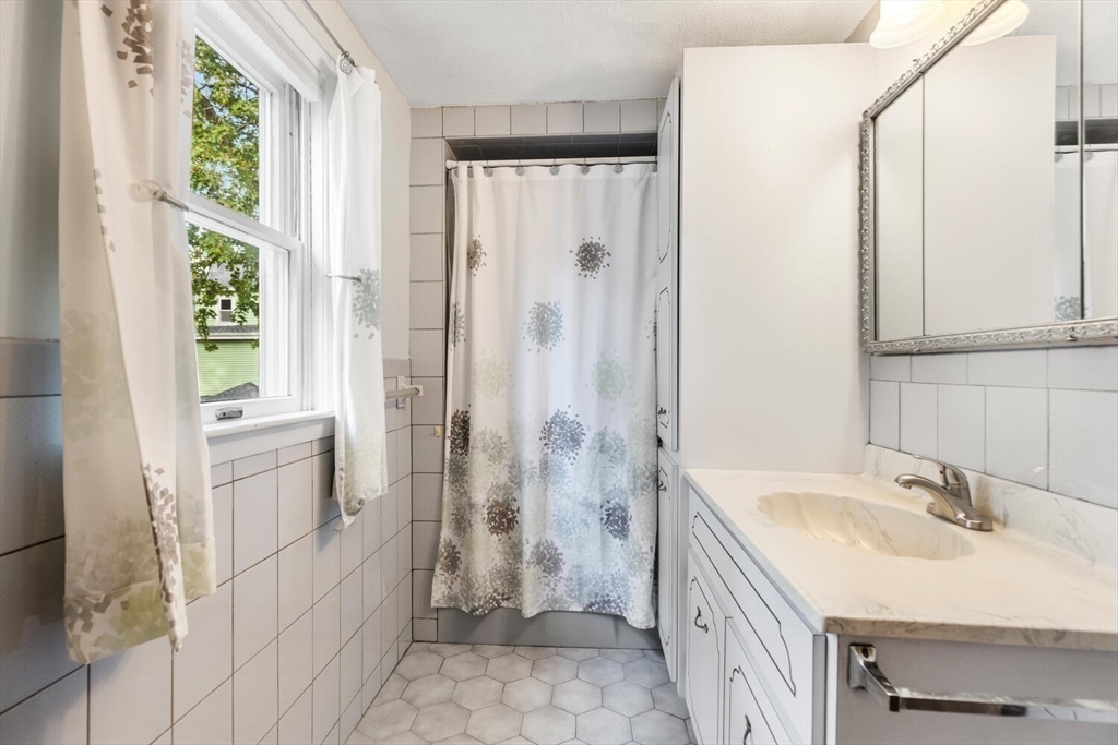 20 Fairmount Street, Unit 2 Everett, MA 02149 - Photo 9 of 12 a bathroom with a sink a toilet and shower