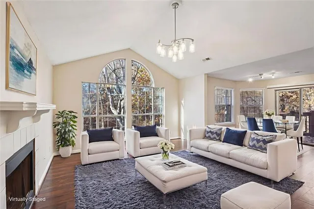 a living room with furniture chandelier and a fireplace