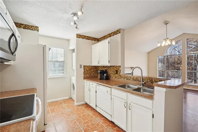 a kitchen with sink cabinets and window