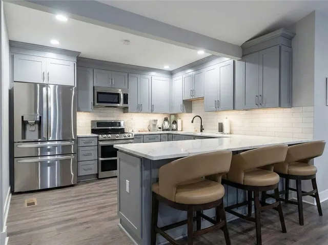 a room with lots of furniture a window and a table