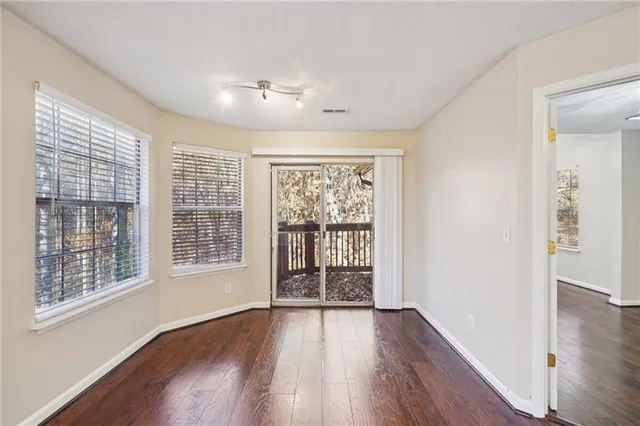 wooden floor in an empty room with a window