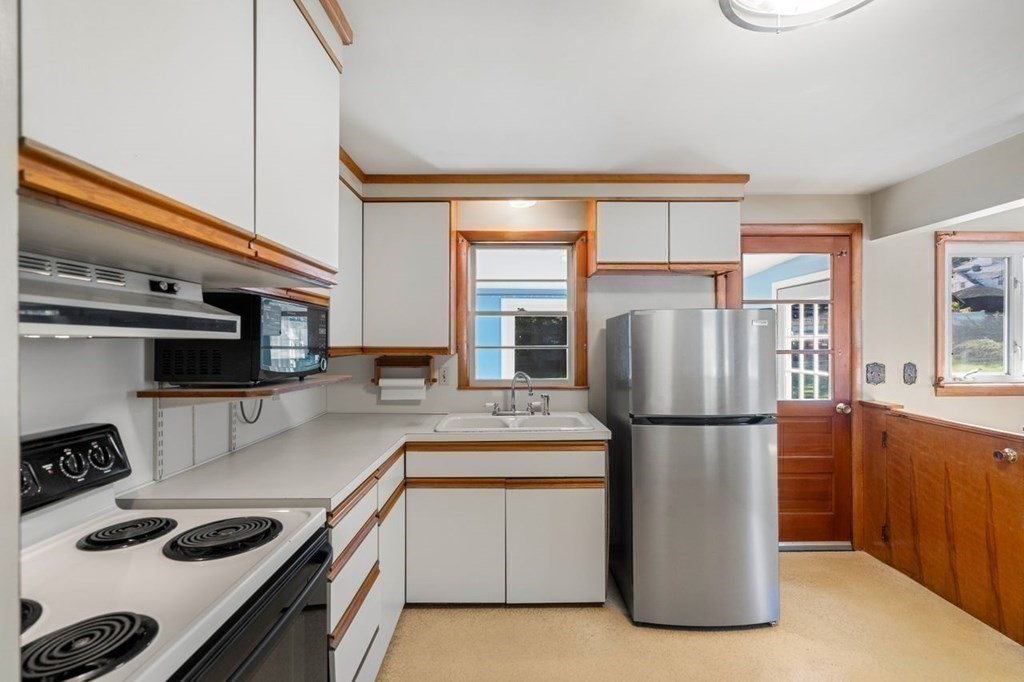 9 Butler Street Worcester, MA 01607 - Photo 12 of 39 a kitchen with a refrigerator a stove and a sink