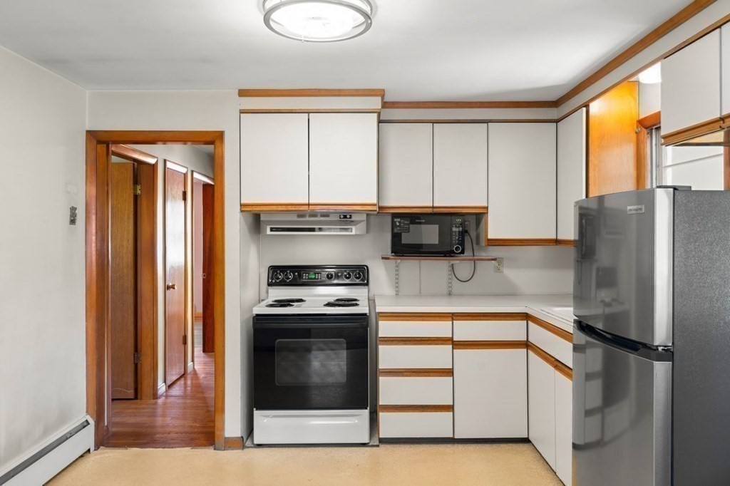 9 Butler Street Worcester, MA 01607 - Photo 14 of 39 a kitchen with stainless steel appliances granite countertop a refrigerator a stove and a sink