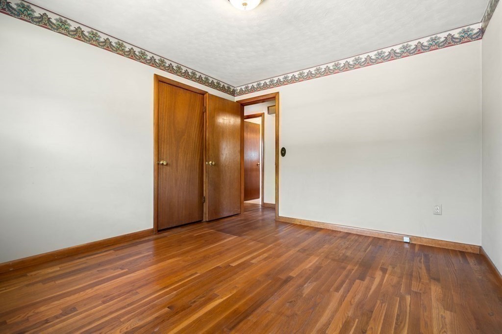 9 Butler Street Worcester, MA 01607 - Photo 16 of 39 a view of an empty room with wooden floor and a window