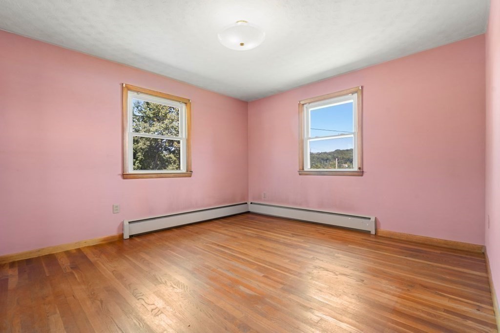 9 Butler Street Worcester, MA 01607 - Photo 17 of 39 a view of an empty room with wooden floor and a window