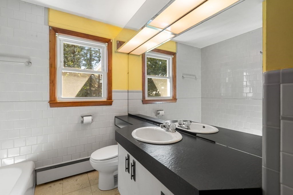 9 Butler Street Worcester, MA 01607 - Photo 21 of 39 a bathroom with a sink toilet and mirror