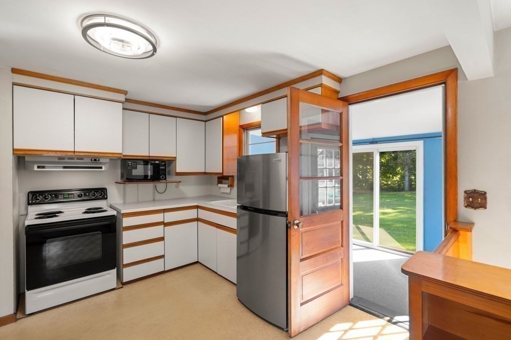 9 Butler Street Worcester, MA 01607 - Photo 9 of 39 a kitchen with stainless steel appliances granite countertop a refrigerator a stove and a sink