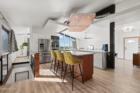 a kitchen with a sink a large window and a chandelier