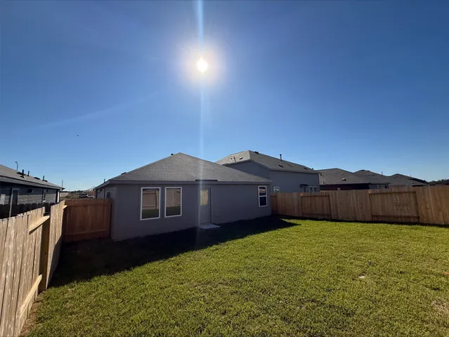 a front view of a house with yard and green space