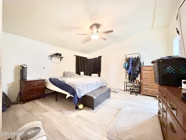 a bedroom with a bed window and wall painting