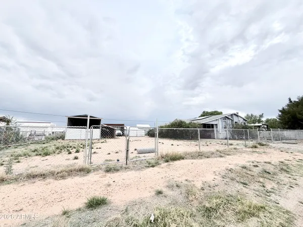 a view of a dry yard with a house