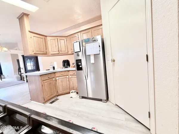 a kitchen with a stove a sink and white cabinets