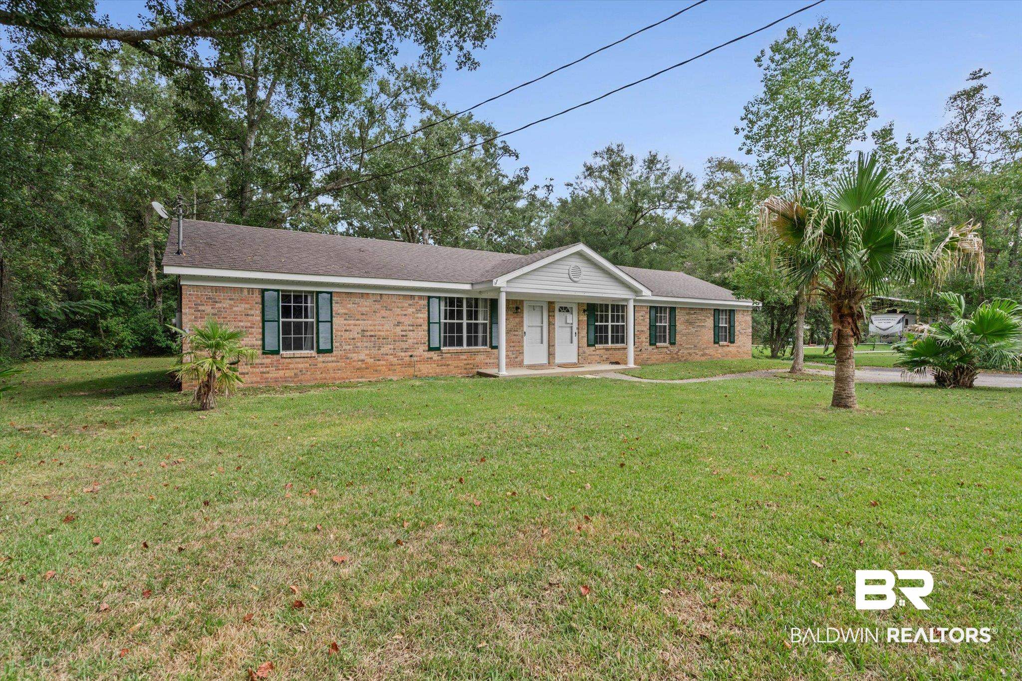 14165 River Oaks Road, Unit A & B Coden, AL 36523 - Photo 33 of 35 Ranch-style house featuring a front yard, brick siding, a shingled roof, and covered porch
