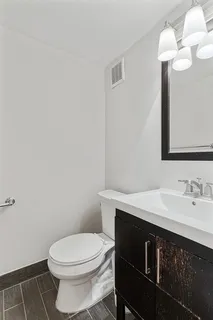a bathroom with a sink a toilet and a mirror