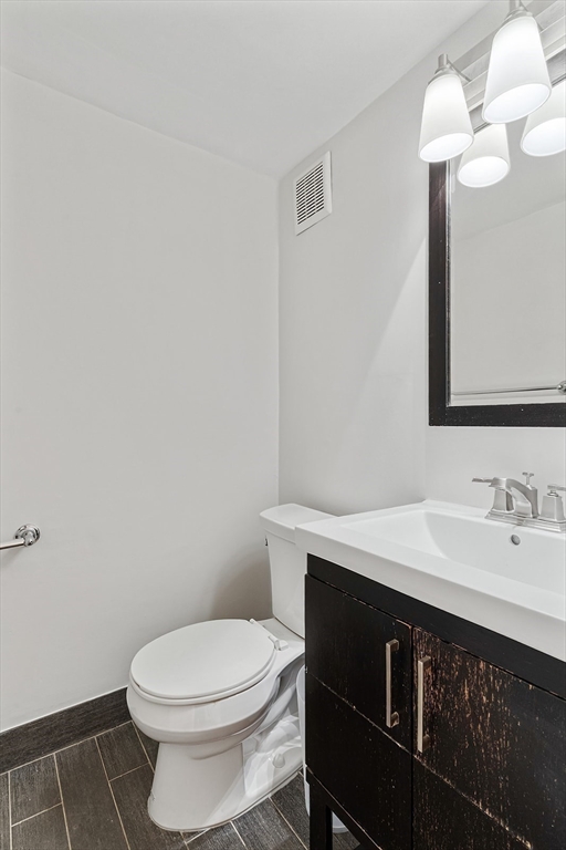 12 Stoneholm Street, Unit 614 Boston, MA 02115 - Photo 12 of 17 a bathroom with a sink a toilet and a mirror