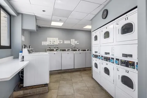 a kitchen with kitchen island a white stove top oven and cabinets
